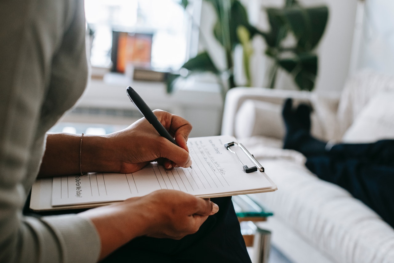 Psychologist Taking Notes on a Clipboard